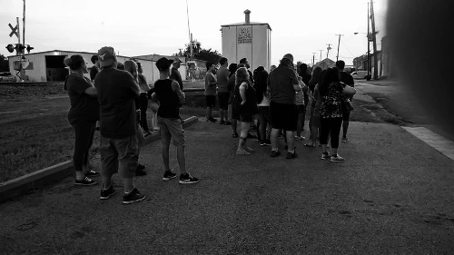 Large group of tourists participating in a nighttime Terrell Ghost Walks walking tour
